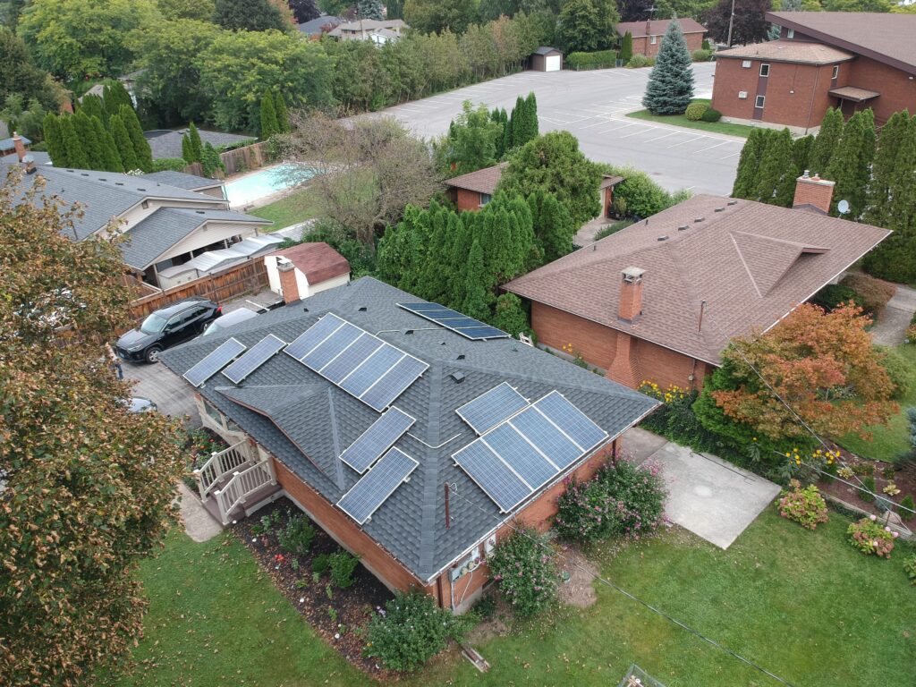 Bungalow in St. Catharines with solar panels on a new dark shingle roof, aerial view