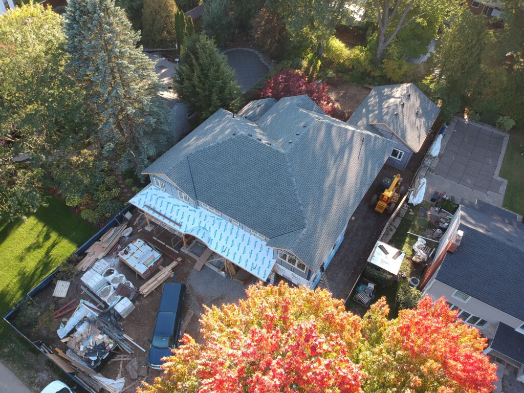 Ancaster home with a new grey shingle roof surrounded by autumn trees