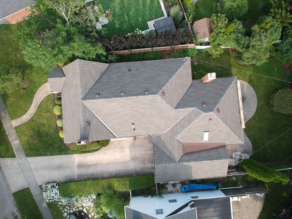 Aerial view of a home with a new grey architectural shingle roof